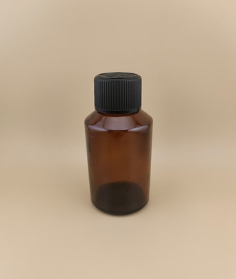 طراحی ظریف، بطری شیشه ای گرد و صاف قهوه ای روشن با درپوش مخصوص برای دارو